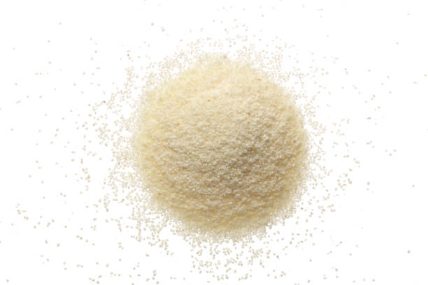 istock raw semolina isolated on white background. Top view 917553888