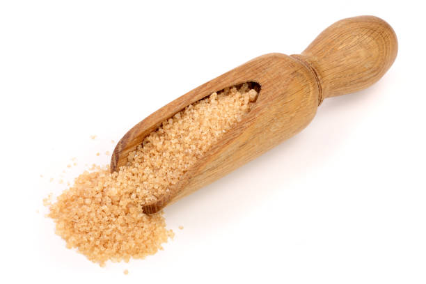 istock brown sugar in wooden scoop isolated on white background 917554526