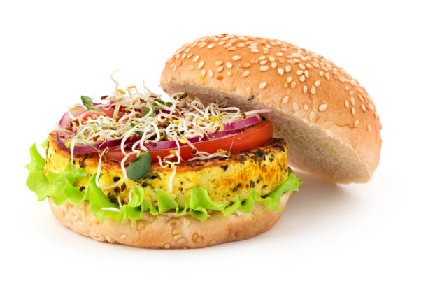 Opened vegan burger with grilled tofu cheese, vegetables and micro greens isolated on white background stock photo