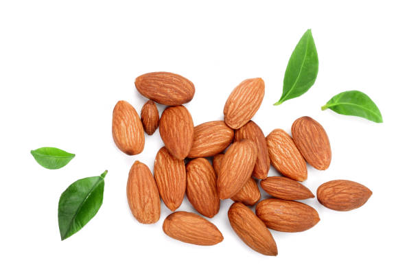 istock almonds with leaves isolated on white background. Top view. Flat lay 917555376