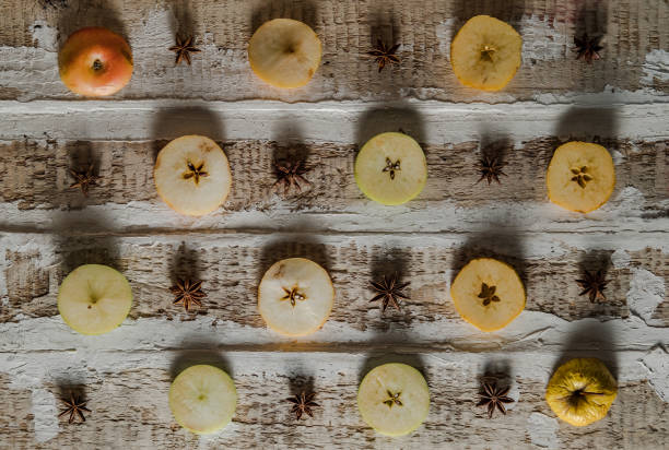 istock apples cut in circles with star anise on a rough wooden surface 917558194