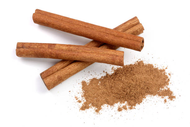 istock Cinnamon sticks with powder isolated on white background. Top view 917558576
