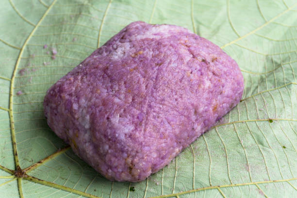 brown rice with purple yam in leaf Red or brown rice with purple yam in leaf, the Kadazandusun traditional dish locally known as Linopot. Closeup selective focusing kadazandusun stock pictures, royalty-free photos & images