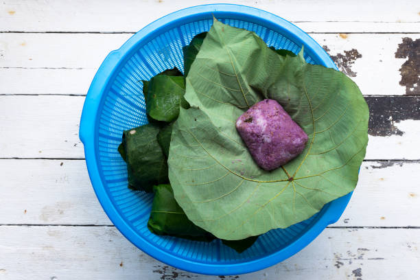 brown rice with purple yam in leaf Red or brown rice with purple yam in leaf, the Kadazandusun traditional dish locally known as Linopot. kadazandusun stock pictures, royalty-free photos & images