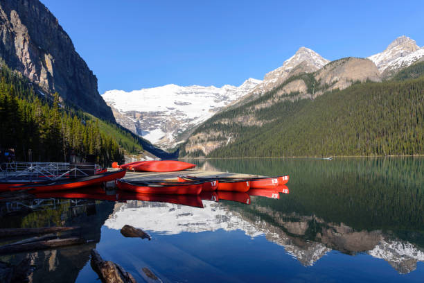 istock Serene Lake Louise surrounded by greenery with reflection, Alberta, Canada 917566118