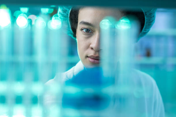 African American biochemist working with test tubes in laboratory.