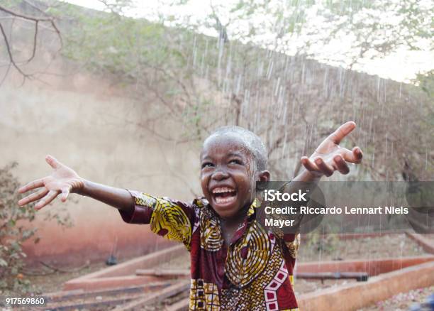Sweet Little African Boy Under The Rain In Mali Stock Photo - Download Image Now