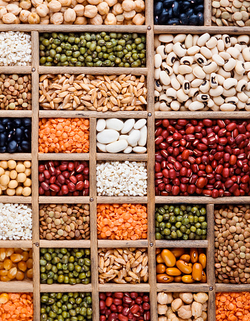 composition of grain, seeds and  legumes in a wood tray, perpendicular texture
