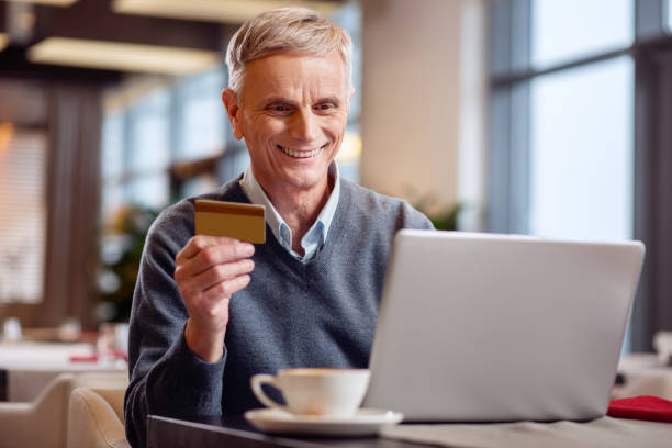 istock Happy mature man paying online 917577768