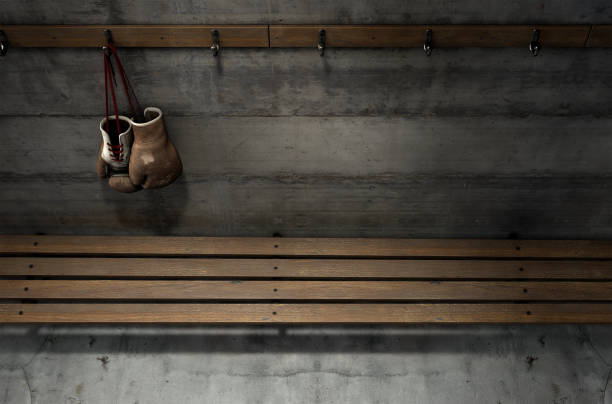 istock Worn Vintage Boxing Gloves Hanging In Change Room 917580732