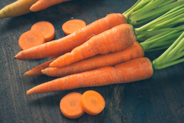 Fresh Carrot With Slice On Wooden Background