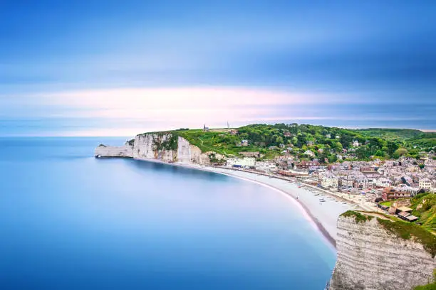 Etretat village and its bay beach, aerial view from cliff. Normandy, France, Europe. Long exposure photography