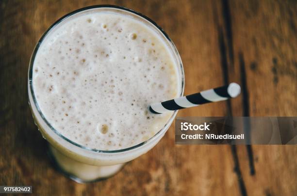 Frothy Ice Coffee In Glass With Drinking Straw On Wooden Background Top View Close Up Stock Photo - Download Image Now