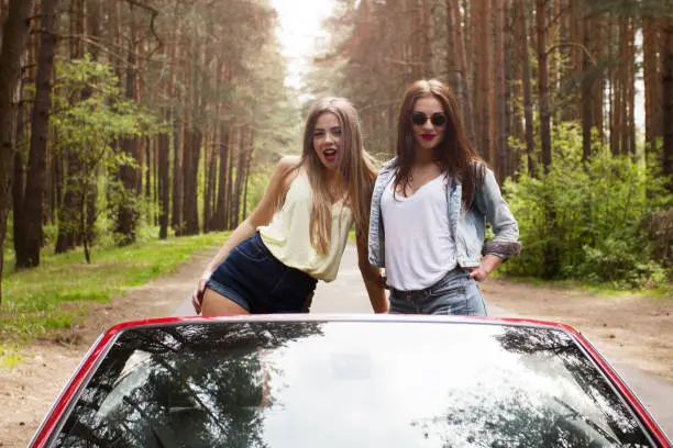 two cool girls having fun in cabrio