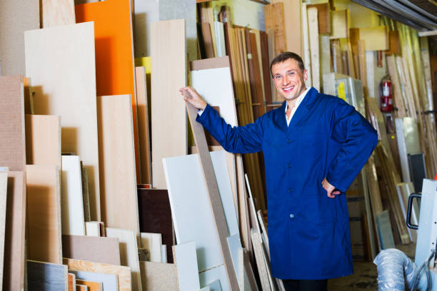 istock Man wearing protective workwear standing with plywood in store 917583892