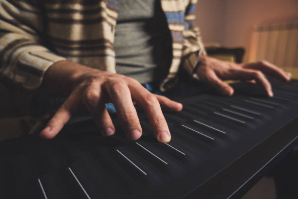 istock Musician playing on the keyboard synthesizer 917590144