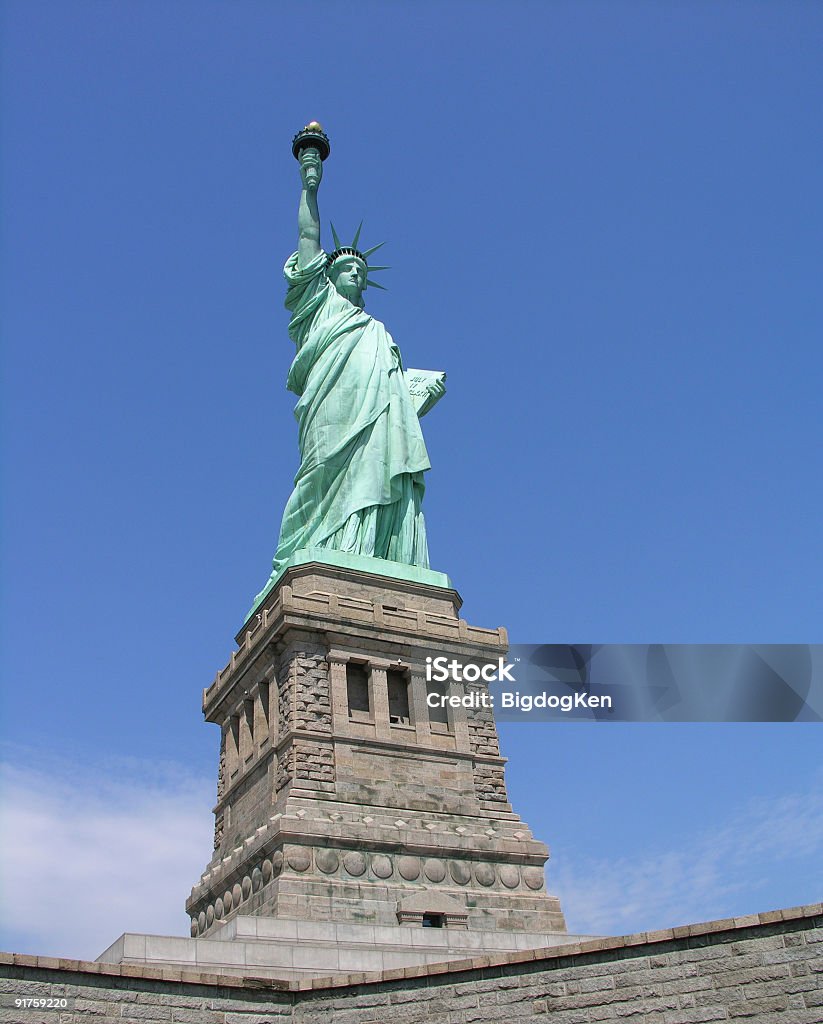 Statue Of Liberty A full-length photo of the Statue Of Liberty including the base and pedestal. Blue Stock Photo