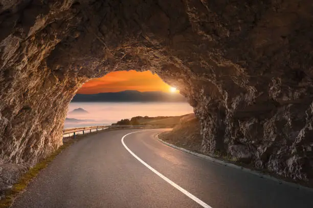 Photo of Old road tunnel in mountains at beautiful sunrise
