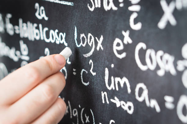 istock Professor writing mathematical formula and equation to blackboard in school classroom. College or university teacher or student with chalkboard. 917599168