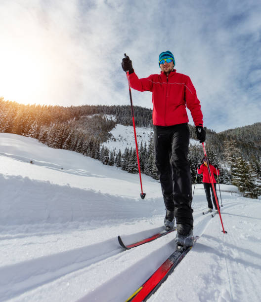 istock Cross-country skiing. Young man and woman doing exercise 917601554