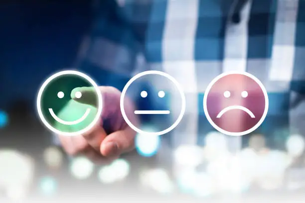 Photo of Business man giving rating and review with happy, neutral or sad face icons. Customer satisfaction and service quality survey.