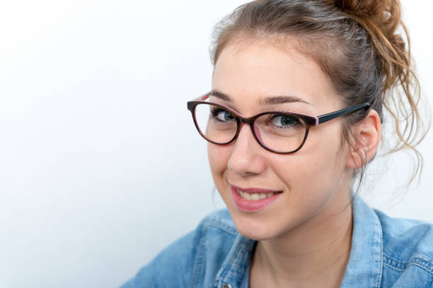 a smiling young woman with black glasses