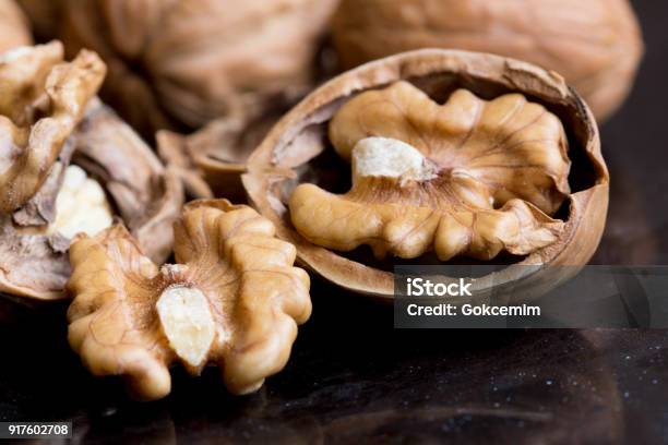 Macro Of Walnuts On Black Background Stock Photo - Download Image Now - Walnut, Walnut Tree, Nut - Food