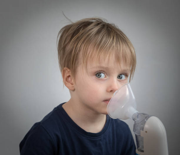 istock Little boy takeing inhalation for respiratory didease 917603126