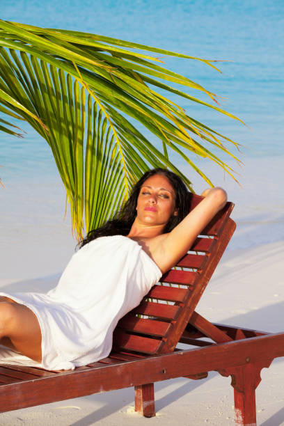 istock Girl is sunbathing on sunbeds 917605628