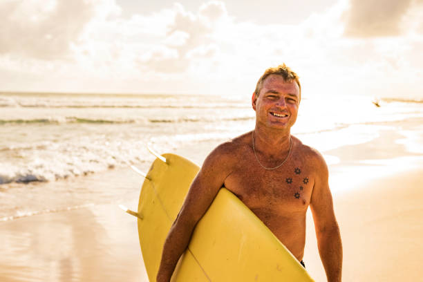 istock Man About to go Surfing at the Beach 917606192