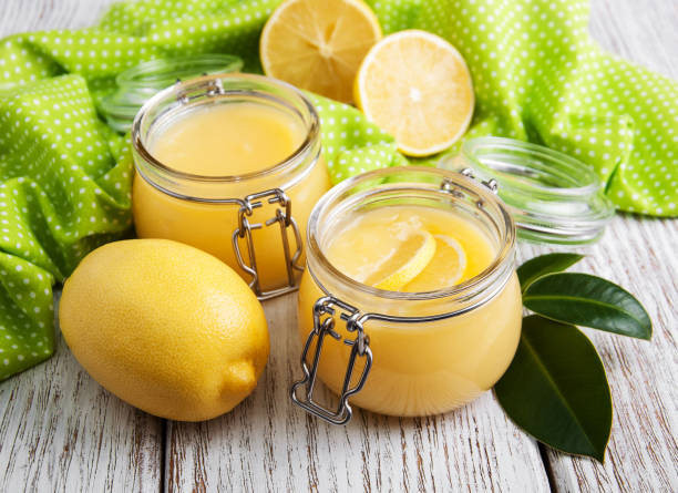 istock Lemon curd in glass jar with fresh lemons 917606568