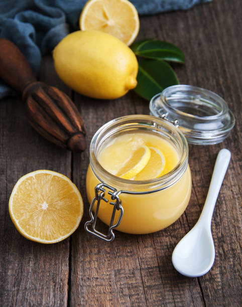 istock Lemon curd in glass jar with fresh lemons 917606586
