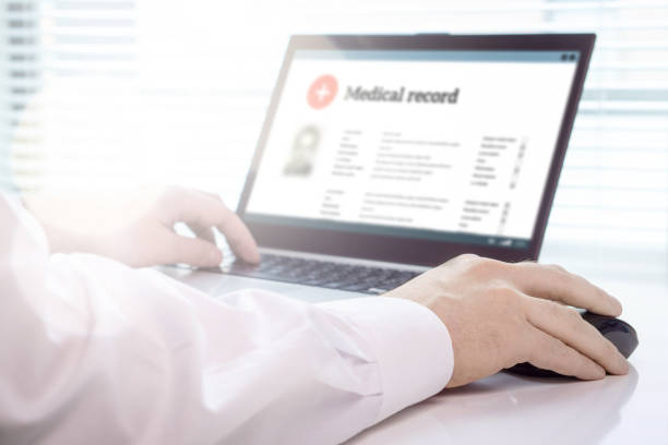 istock Doctor using laptop and electronic medical record (EMR) system. Digital database of patient's health care and personal information on computer screen. 917611012