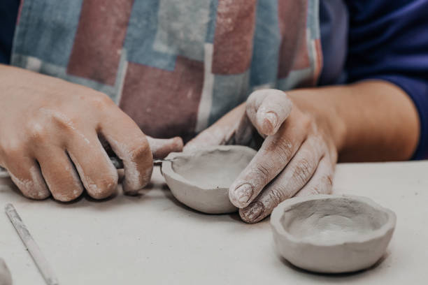 istock Female potter works with clay, craftsman hands close up 917614472
