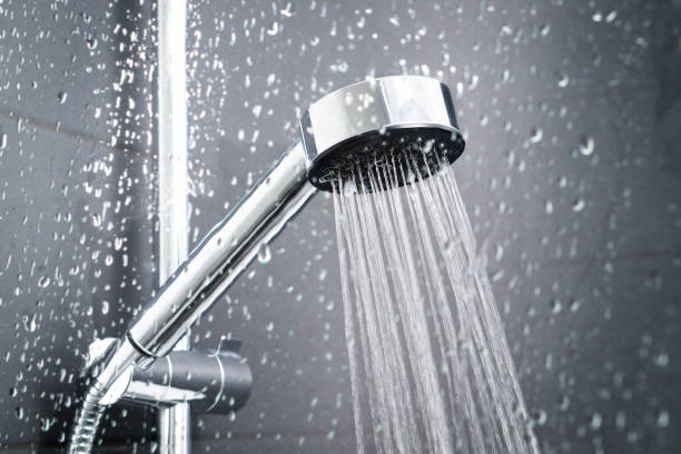 istock Fresh shower behind wet glass window with water drops splashing. 917616066