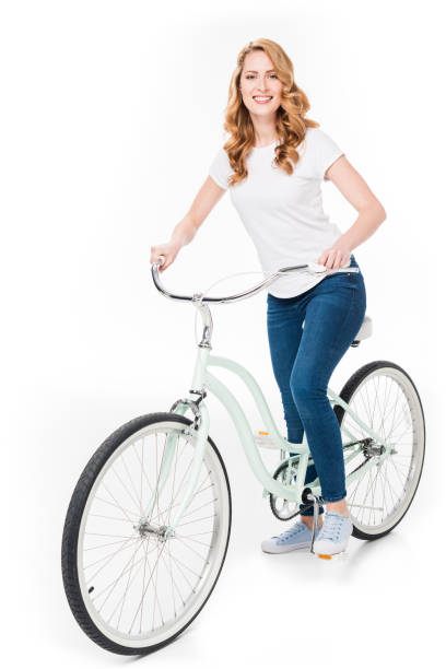 istock cheerful woman with retro bicycle looking at camera isolated on white 917618700