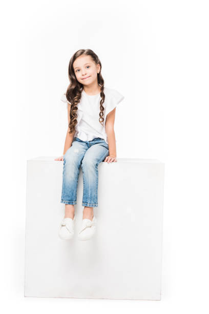 istock smiling kid sitting on blank cube isolated on white 917619812