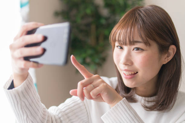 istock Young woman using smart phone in living room 917626318