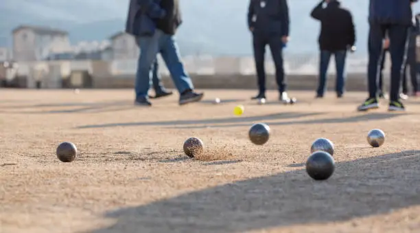 Photo of Friends Plays With Petanque Bowls A French Traditional Game