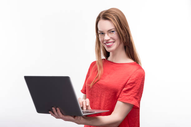 istock Ginger-haired woman in eyeglasses posing with laptop 917629364