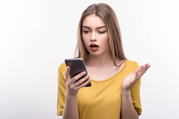 Young woman being indignant about content of message