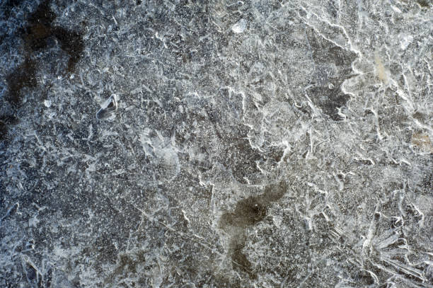 istock texture, background. Frozen water in a pool, a crust surprising pattern frozen water 917630710