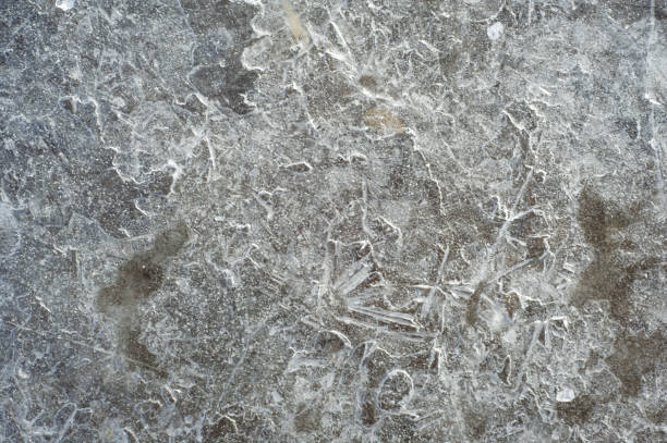 istock texture, background. Frozen water in a pool, a crust surprising pattern frozen water 917630748