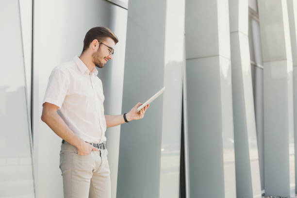 istock Smiling businessman working with tablet outdoors 917633944