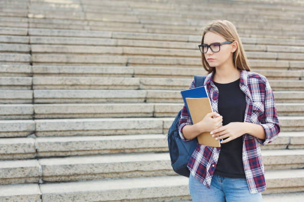 istock Student girl with books on university background 917638486