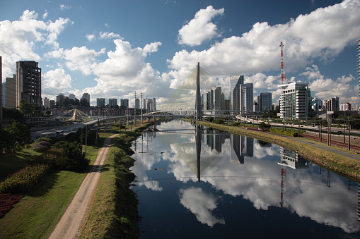 View of Octavio Frias de Oliveira Bridge and Sao Paulo city skyline. The Octavio Frias de Oliveira bridge is a cable-stayed bridge in São Paulo, Brazil over the Pinheiros River.