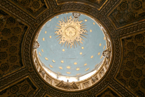 Inside the dome of the Siena, Italy cathedral showing trompe l'oeil design of the gilded dome and the painting of the sky.