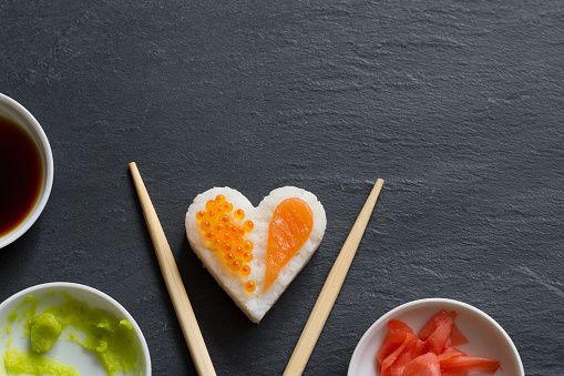Sushi abstract seafood heart concept on black marble menu background idea