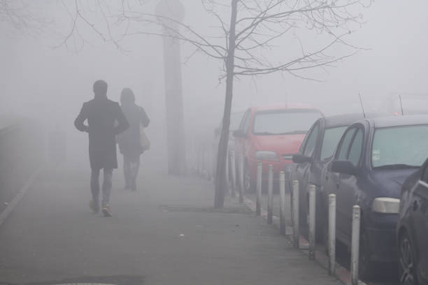 istock People walk in heavy fog 917642800