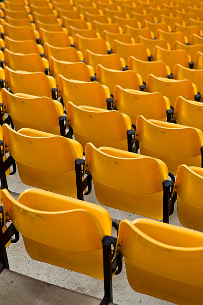 istock Anticipation: Rows of empty yellow seats in sporting stadium 91764331